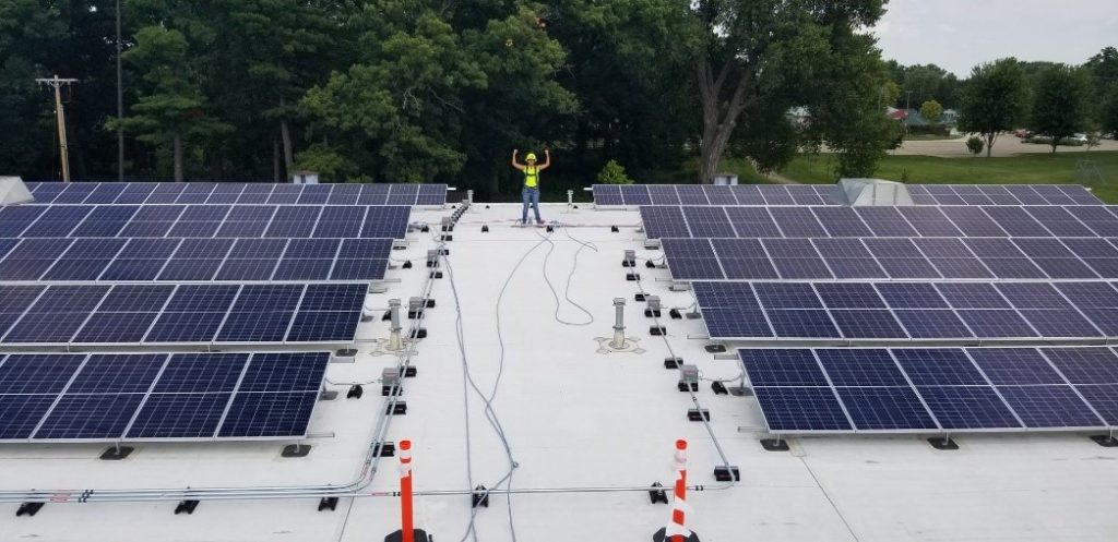 GreenPower participant working on a rooftop solar installation.